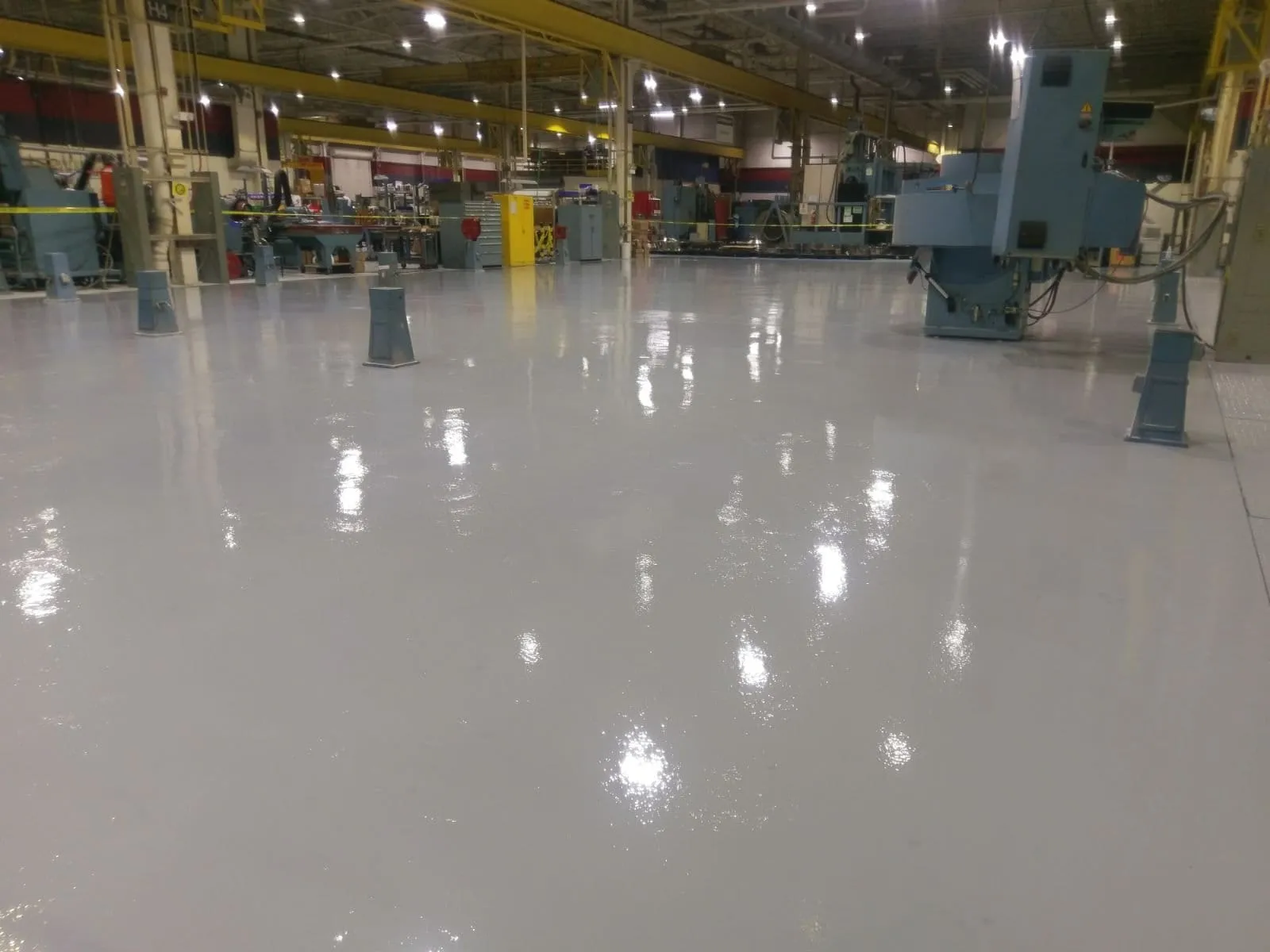 Coated floor running through an industrial plant between equipment
